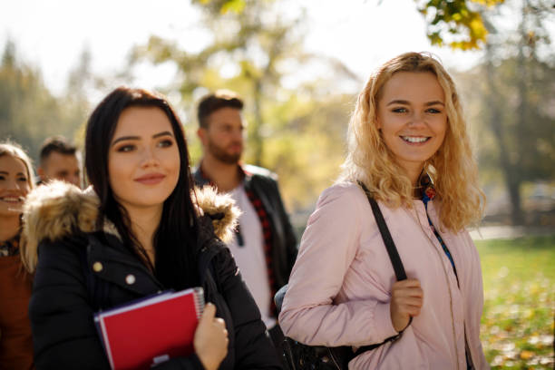 istock Group of college students walking on university campus 1019565146
