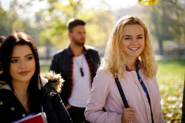 istock Group of college students walking on university campus 1019565224