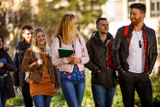 istock Group of college students walking on university campus 1019565676