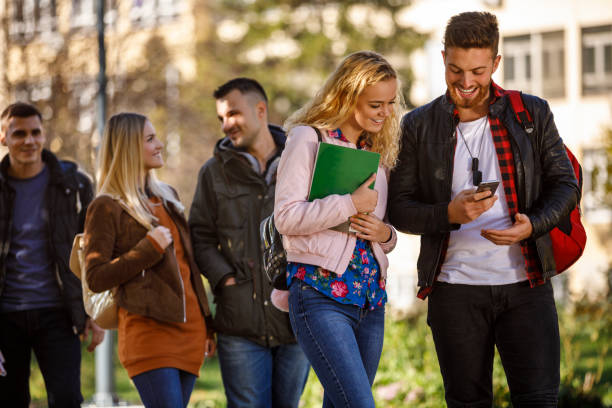 istock College students using mobile phone outdoors 1019565784