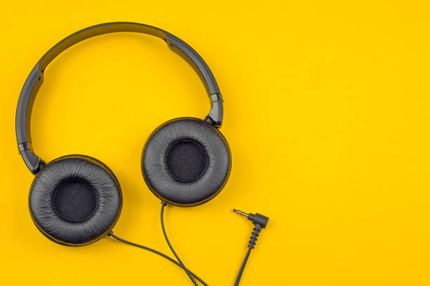 istock black headphones on a yellow background 1019572166