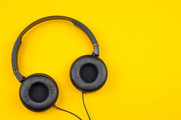 istock black headphones on a yellow background 1019572168
