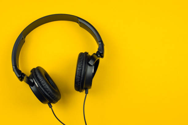 istock black headphones on a yellow background 1019572182