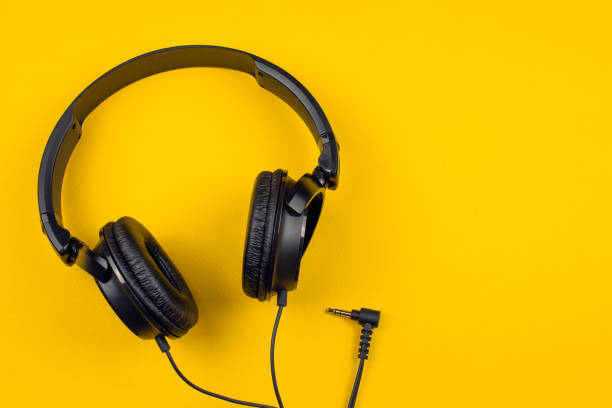 istock black headphones on a yellow background 1019572188