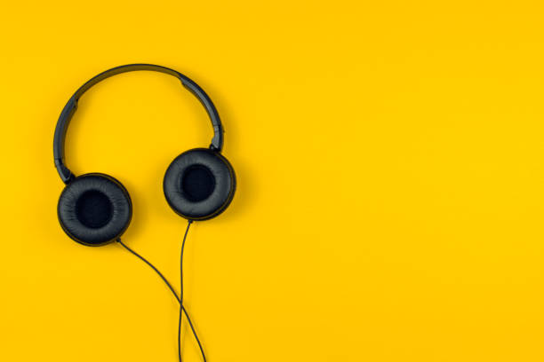 istock black headphones on a yellow background 1019572192