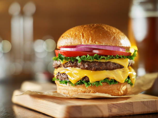 istock double cheeseburger with lettuce, tomato, onion, and melted american cheese 1019576426
