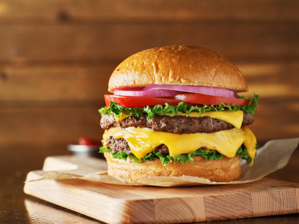 istock double cheeseburger with lettuce, tomato, onion, and melted american cheese 1019576430