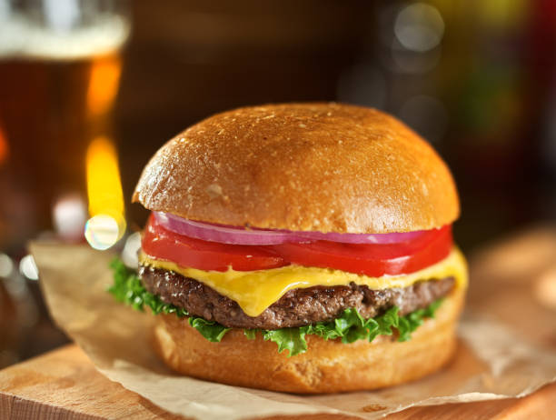 istock tasty cheeseburger with beer in background 1019576474
