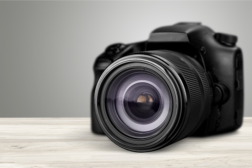Professional DSLR Camera and lens on black background.