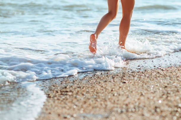 istock Women's beautiful sexy legs on the beach 1019597460
