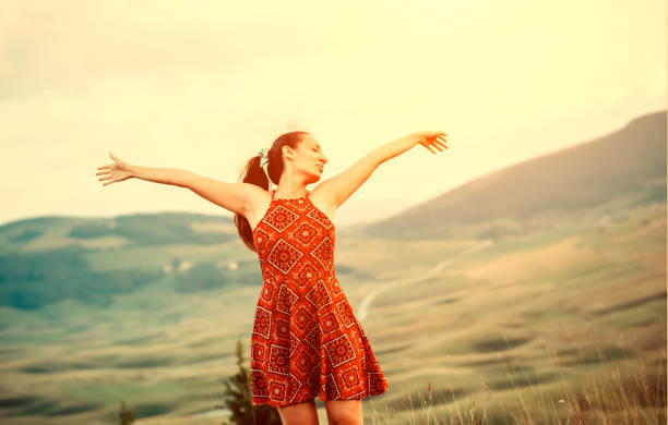 istock Young woman standing on top of mountain 1019603146