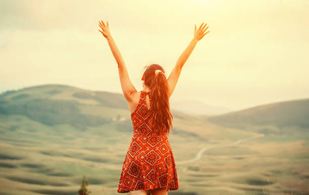 istock Young woman standing on top of mountain 1019603246