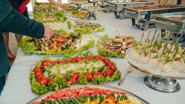 istock buffet: people take food in plates. 1019611252