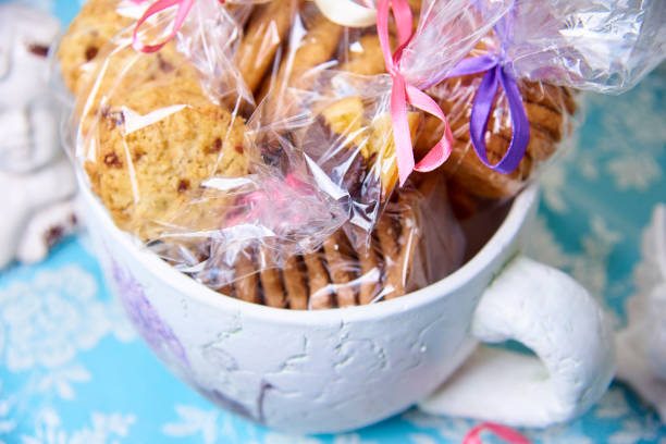 istock Gift packages with cookies with bright ribbons in a large cup close-up. 1019614892
