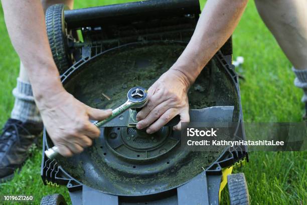 Diy Replacing A Lawn Mower Blade Stock Photo - Download Image Now - Lawn Mower, Blade, Repairing