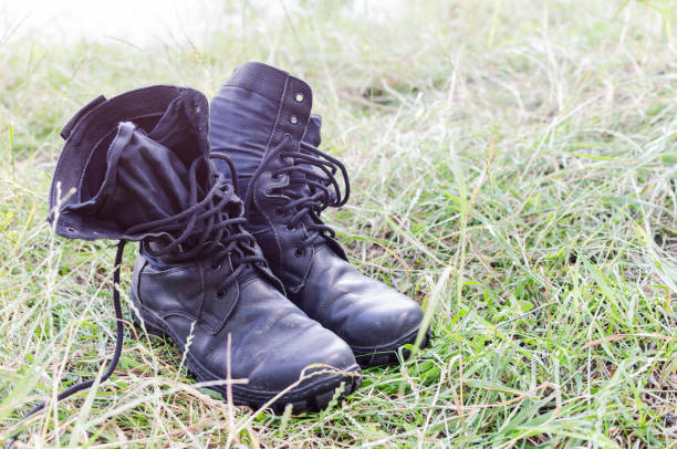 istock A pair of old worn boots in the grass 1019629596