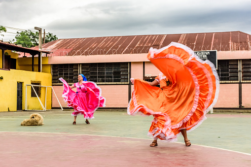 San Juan del Obispo, Guatemala -  August 3, 2018: Folk dancers from El Salvador perform in basketball court in village near UNESCO World Heritage Site of Antigua.