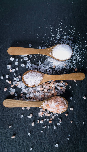 Different types of salt. Top view on three wooden spoons