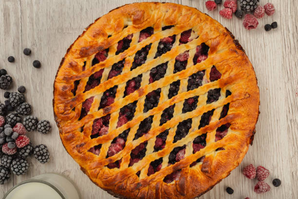 istock Berry pie on a wooden background with ingredients 1019648210