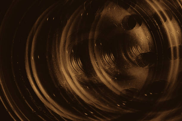 istock Monochrome multi exposition background of oil filter close up. Artwork from auto part in macro photography. Sepia tones. 1019656494