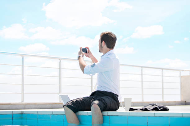 istock working on laptop at the pool, work on holiday concept 1019670884