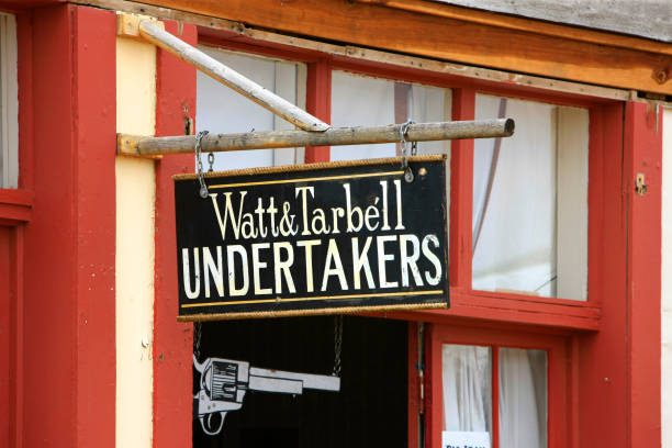 Hanging overhead sign outside Watt & Tarbell Undertakers on E. Allen St in historic Tombstone, Arizona Hanging overhead sign outside Watt & Tarbell Undertakers on E. Allen St in historic Tombstone, Arizona the undertaker stock pictures, royalty-free photos & images