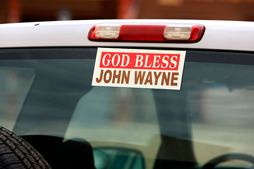 God Bless John Wayne bumper sticker on the rear window of a truck seen in Tombstone, Arizona