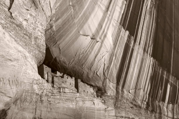 Beautiful black and white monochrome picture of Anazasi cave dwellings built in a cliff in Canyon de Chelly, Chinle, Arizona.