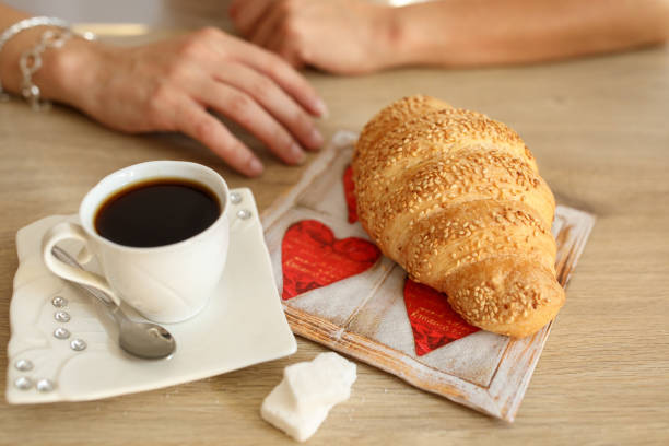 istock Woman having croissant and coffee for breakfast 1019679296