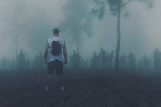istock Young adult against zombie hordes 1019682226