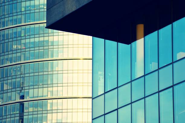 istock Modern office building facade abstract fragment, shiny windows in steel structure, retro stylized colorful tonal filter effect 1019689434