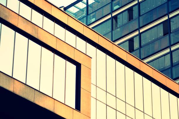 istock Modern office building facade abstract fragment, shiny windows in steel structure, retro stylized colorful tonal filter effect 1019689556
