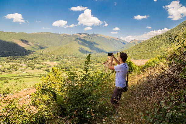 istock Guy taking photo with smartphone 1019689778