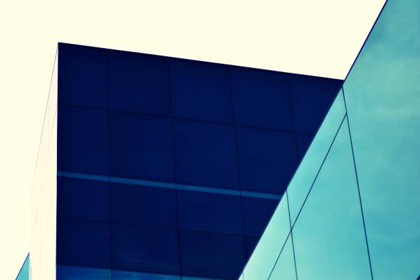 istock Modern office building facade abstract fragment, shiny windows in steel structure, retro stylized colorful tonal filter effect 1019690100