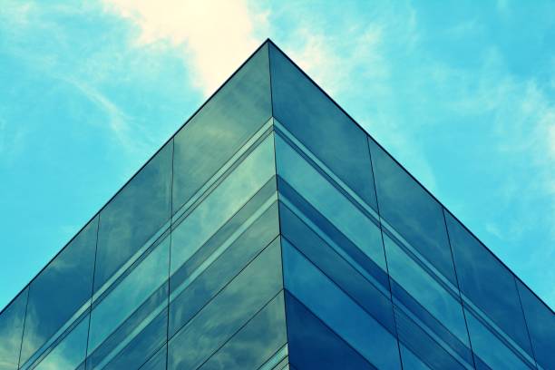 istock Modern office building facade abstract fragment, shiny windows in steel structure, retro stylized colorful tonal filter effect 1019691986