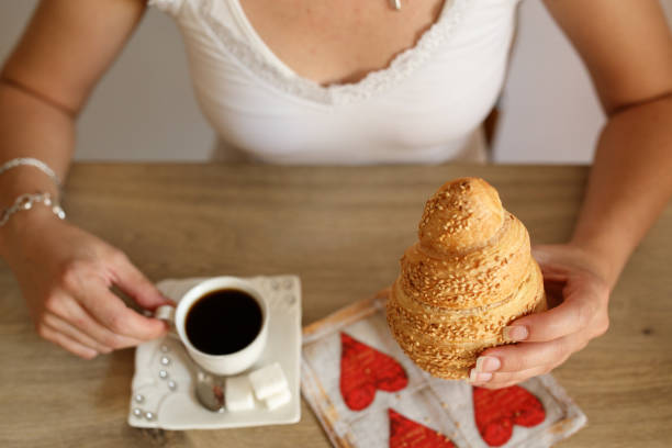 istock Woman having croissant and coffee for breakfast 1019694576