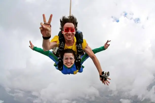Skydiving tandem peace and love sign