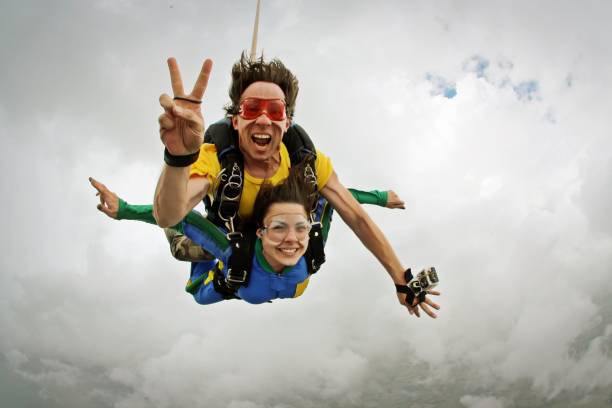 Skydiving tandem happiness on a cloudy day stock photo
