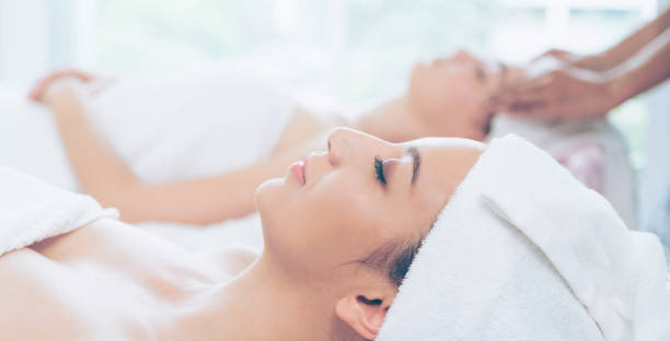 istock Relaxed young woman lying on spa bed for massage. 1019709636