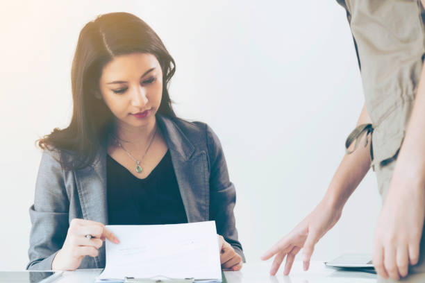 istock Businesswoman reads and talks with partner. 1019709772