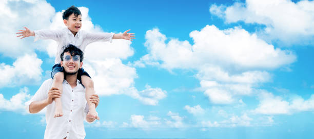 istock Happy father carry son on shoulders on vacation. 1019716256