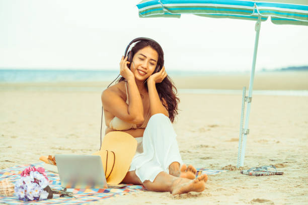 istock Plus size young woman sitting on the beach. 1019716298
