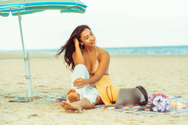 istock Plus size young woman sitting on the beach. 1019716328