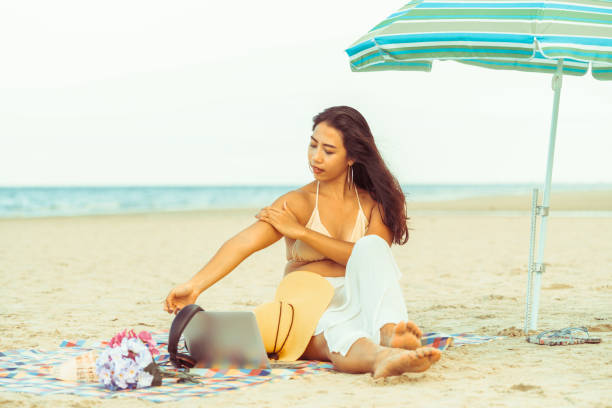 istock Plus size young woman sitting on the beach. 1019716334