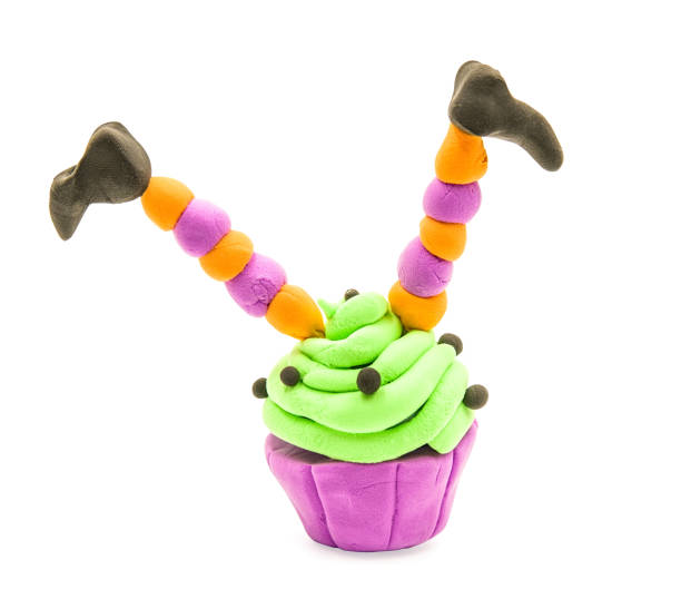 fake clay cupcake halloween craft with witch legs isolated on white with clipping path halloween concept. creative plasticine cupcake craft isolated on white. hand made fake clay craft polymer clay sweets stock pictures, royalty-free photos & images