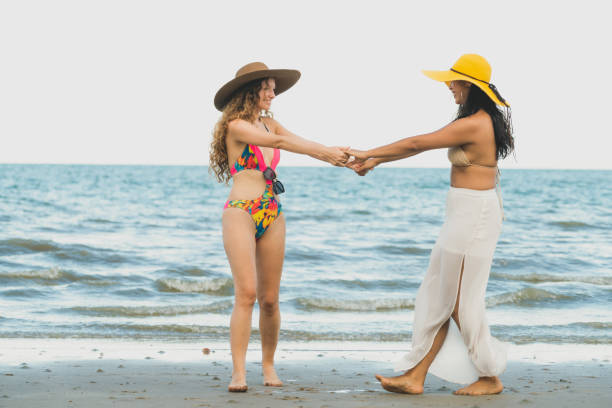 istock Happy women dance on sand beach in summer. 1019726978