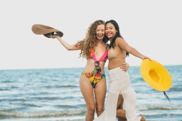 istock Happy women dance on sand beach in summer. 1019727012