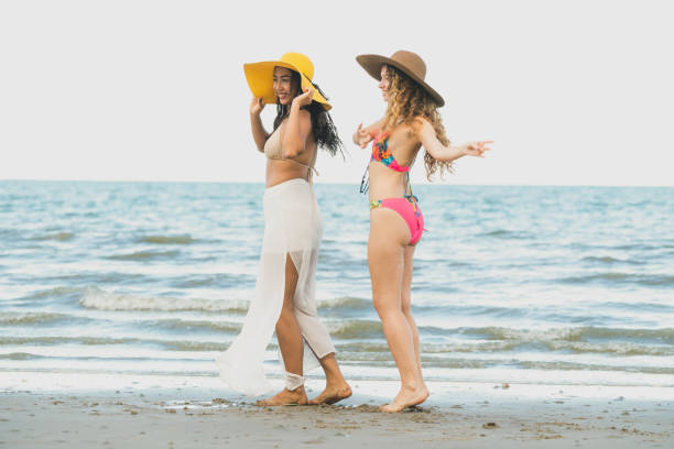 istock Happy women dance on sand beach in summer. 1019727016