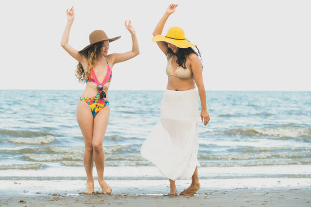 istock Happy women dance on sand beach in summer. 1019727022