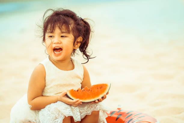 istock Adorable kid eating watermelon on the beach. 1019727032